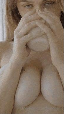 Meg pouring milk all over her boobies